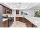 Well-equipped kitchen with dark wood cabinets and tile countertops at 8620 Cremona Dr, Las Vegas, NV 89117