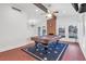 Bright living room with a pool table, high ceilings, exposed beam, and stylish lighting at 8620 Cremona Dr, Las Vegas, NV 89117