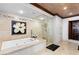 Luxurious bathroom featuring a soaking tub, glass-enclosed shower, and elegant tile work at 9103 Alta Dr # 602, Las Vegas, NV 89145