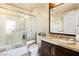 Bright bathroom featuring a glass-enclosed shower, marble countertops, and dark wood cabinetry at 9103 Alta Dr # 602, Las Vegas, NV 89145