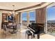 Elegant dining area featuring a piano, cityscape views, modern chandelier, and upscale finishes at 9103 Alta Dr # 602, Las Vegas, NV 89145