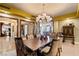 Formal dining room includes chandelier, ample seating, and decorative wall treatments at 9103 Alta Dr # 602, Las Vegas, NV 89145