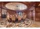 Elegant formal dining room featuring a custom ceiling mural, ornate chandelier and beautiful wood paneling at 9103 Alta Dr # 602, Las Vegas, NV 89145