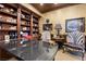 Refined home office featuring rich wood finishes, custom shelving, and a large desk with elegant chairs at 9103 Alta Dr # 602, Las Vegas, NV 89145