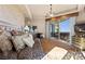 Comfortable bedroom featuring a chandelier, patterned bedding, and an open balcony at 9103 Alta Dr # 602, Las Vegas, NV 89145