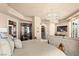 Elegant main bedroom featuring a stylish chandelier and a cozy sitting area with beautiful views at 9103 Alta Dr # 602, Las Vegas, NV 89145