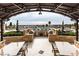 Outdoor kitchen with built-in grill, counter space, and seating area overlooking the pool and city views at 9103 Alta Dr # 602, Las Vegas, NV 89145