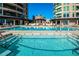 Resort-style pool area surrounded by lounge chairs and lush landscaping, nestled between luxury condos at 9103 Alta Dr # 602, Las Vegas, NV 89145