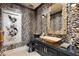 Chic powder room boasting a unique vessel sink, artistic wallpaper, and modern fixtures at 9103 Alta Dr # 602, Las Vegas, NV 89145