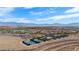 Aerial view of the neighborhood showcasing tennis & pickleball courts with mountain views and beautiful desert landscaping at 950 Overland Trl, Mesquite, NV 89034