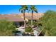 Aerial view of a private backyard oasis with pool, patio furniture, and lush landscaping at 950 Overland Trl, Mesquite, NV 89034
