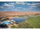Stunning aerial view showcasing the community pool, a lake, and a pristine golf course against a desert backdrop at 950 Overland Trl, Mesquite, NV 89034