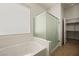 Well-lit bathroom featuring a shower, soaking tub, and window at 950 Overland Trl, Mesquite, NV 89034