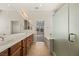 Large bathroom featuring double sinks, an oversized mirror, and a glass shower at 950 Overland Trl, Mesquite, NV 89034