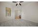 Bedroom with neutral tones, tile flooring, a ceiling fan and a door to the foyer at 950 Overland Trl, Mesquite, NV 89034