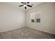 Cozy bedroom featuring carpeted floors, a ceiling fan, and a window with blinds at 950 Overland Trl, Mesquite, NV 89034