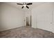 Cozy bedroom showcasing carpet flooring, closet doors, and an open door leading to a bathroom at 950 Overland Trl, Mesquite, NV 89034