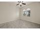 Bright bedroom features marble-look tiled floors, a ceiling fan, and arched windows overlooking the landscape at 950 Overland Trl, Mesquite, NV 89034
