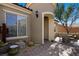 Charming front entrance features a decorative turret, desert landscaping, and a cozy patio area at 950 Overland Trl, Mesquite, NV 89034