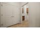 Hallway with neutral flooring, leading to storage and a room with a white vanity and a sink at 950 Overland Trl, Mesquite, NV 89034