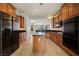 Open kitchen boasts wood cabinetry, granite countertops, and stainless appliances at 950 Overland Trl, Mesquite, NV 89034