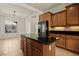 Kitchen boasts a center island, wood cabinets, and stainless refrigerator at 950 Overland Trl, Mesquite, NV 89034