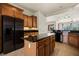 Spacious kitchen features an island, stainless steel refrigerator, and wood cabinetry at 950 Overland Trl, Mesquite, NV 89034
