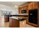 Granite counters complement the wooden cabinets and mosaic backsplash at 950 Overland Trl, Mesquite, NV 89034