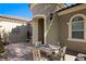 Inviting front patio area with a quaint dining set and a charming sun decoration at 950 Overland Trl, Mesquite, NV 89034