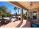 A covered patio with ceiling fan and multiple seating areas overlooking the pool at 950 Overland Trl, Mesquite, NV 89034