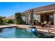 Lush backyard showcasing a refreshing pool, outdoor kitchen, and comfortable seating area at 950 Overland Trl, Mesquite, NV 89034