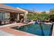 Inviting pool area featuring lush greenery, outdoor seating, and a built-in barbecue at 950 Overland Trl, Mesquite, NV 89034