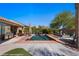 Backyard pool with lounge area, outdoor kitchen, and well-manicured landscaping at 950 Overland Trl, Mesquite, NV 89034