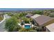 Aerial shot of a pool with a large green garden and an outdoor living space at 950 Overland Trl, Mesquite, NV 89034