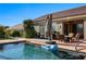 Backyard pool with patio seating, outdoor kitchen, and desert landscaping provides a relaxing outdoor living space at 950 Overland Trl, Mesquite, NV 89034