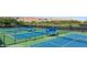Beautiful community tennis courts with blue surfacing and shade structures for players' comfort and enjoyment at 950 Overland Trl, Mesquite, NV 89034