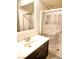 Bathroom with modern shower, framed mirror, and a vanity with dark wood cabinets at 9746 Brooks Lake Ave, Las Vegas, NV 89148