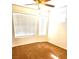 Bedroom with tan carpet, ceiling fan, and natural light from the two windows at 9746 Brooks Lake Ave, Las Vegas, NV 89148