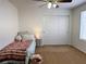 Cozy bedroom featuring neutral carpet, a ceiling fan, and slider closet at 9746 Brooks Lake Ave, Las Vegas, NV 89148