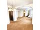 Bright and spacious living room with arched doorway, chandelier and carpet at 9746 Brooks Lake Ave, Las Vegas, NV 89148