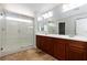 A modern bathroom featuring a double sink vanity, shower, and tile flooring at 1009 Ancient Timber Ave, Henderson, NV 89052