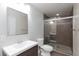 Neutral modern bathroom featuring a glass-enclosed shower, floating vanity, and updated fixtures at 1009 Ancient Timber Ave, Henderson, NV 89052