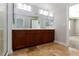 A modern bathroom featuring a double sink vanity, shower, and tile flooring at 1009 Ancient Timber Ave, Henderson, NV 89052