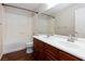 Bathroom featuring a double sink vanity with wood cabinetry and a shower-tub combo at 1009 Ancient Timber Ave, Henderson, NV 89052