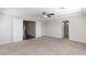 Bedroom with neutral carpet, ceiling fan, white trim, and open door to adjacent room at 1009 Ancient Timber Ave, Henderson, NV 89052