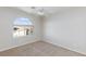 Bright, carpeted bedroom featuring a ceiling fan and window at 1009 Ancient Timber Ave, Henderson, NV 89052