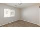 Empty carpeted bedroom featuring a window with blinds at 1009 Ancient Timber Ave, Henderson, NV 89052