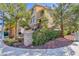 An exterior home view with beautiful palm trees and landscaping, adding to the curb appeal at 1009 Ancient Timber Ave, Henderson, NV 89052