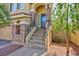 Inviting front entrance with stone accents, steps, decorative railing, and neutral colored paint at 1009 Ancient Timber Ave, Henderson, NV 89052
