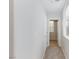 Neutral hallway with carpet, white walls, and an open doorway leading to a bathroom at 1009 Ancient Timber Ave, Henderson, NV 89052